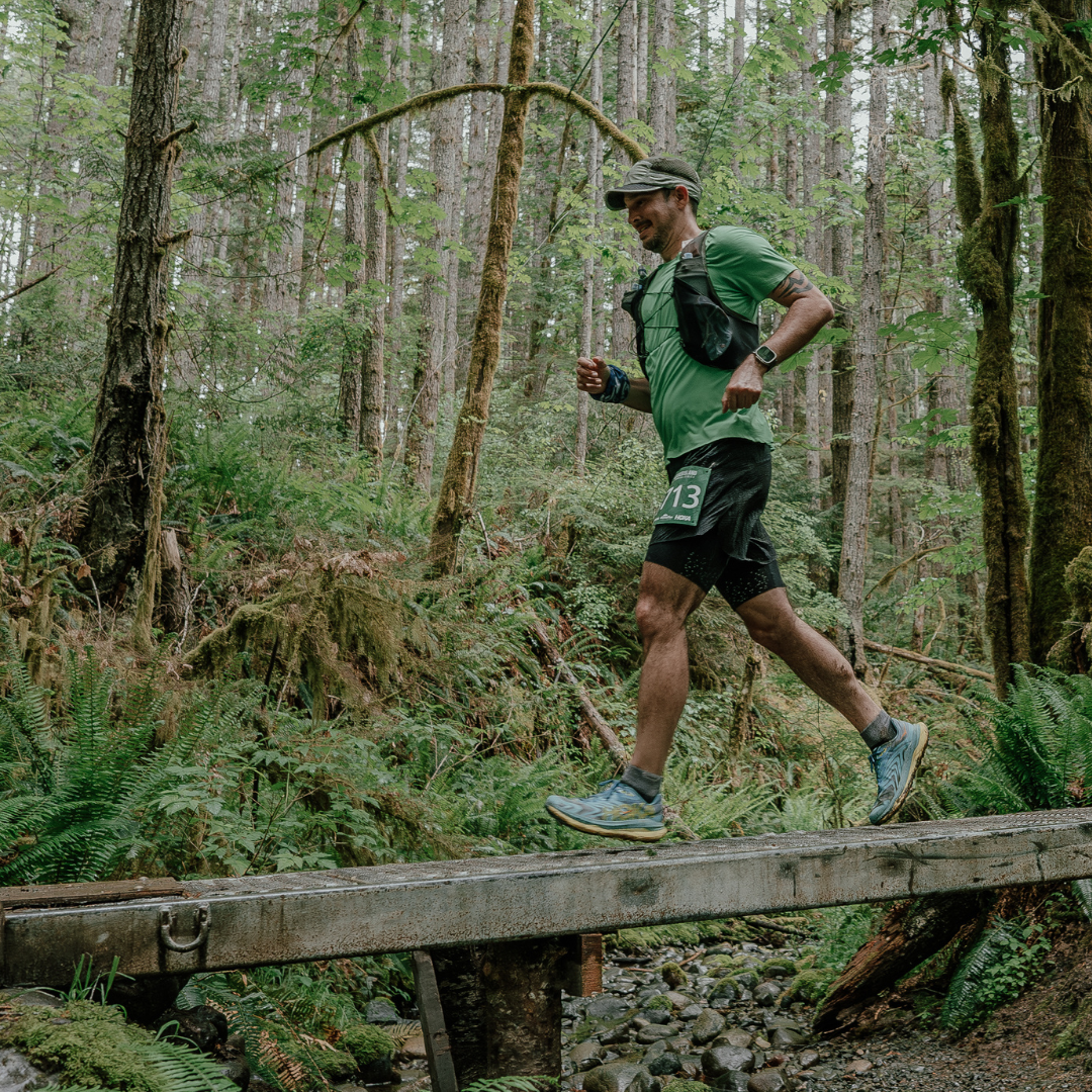 trail runner crossing a bridge